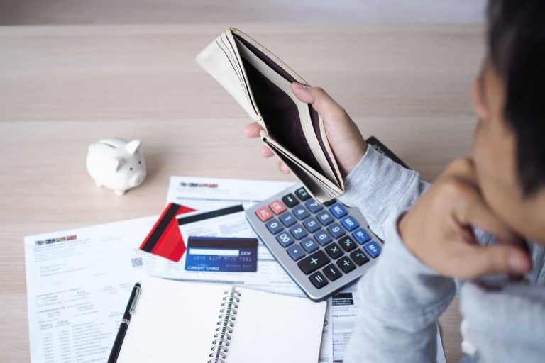 A man thinking whether apply a credit card or a personal loan