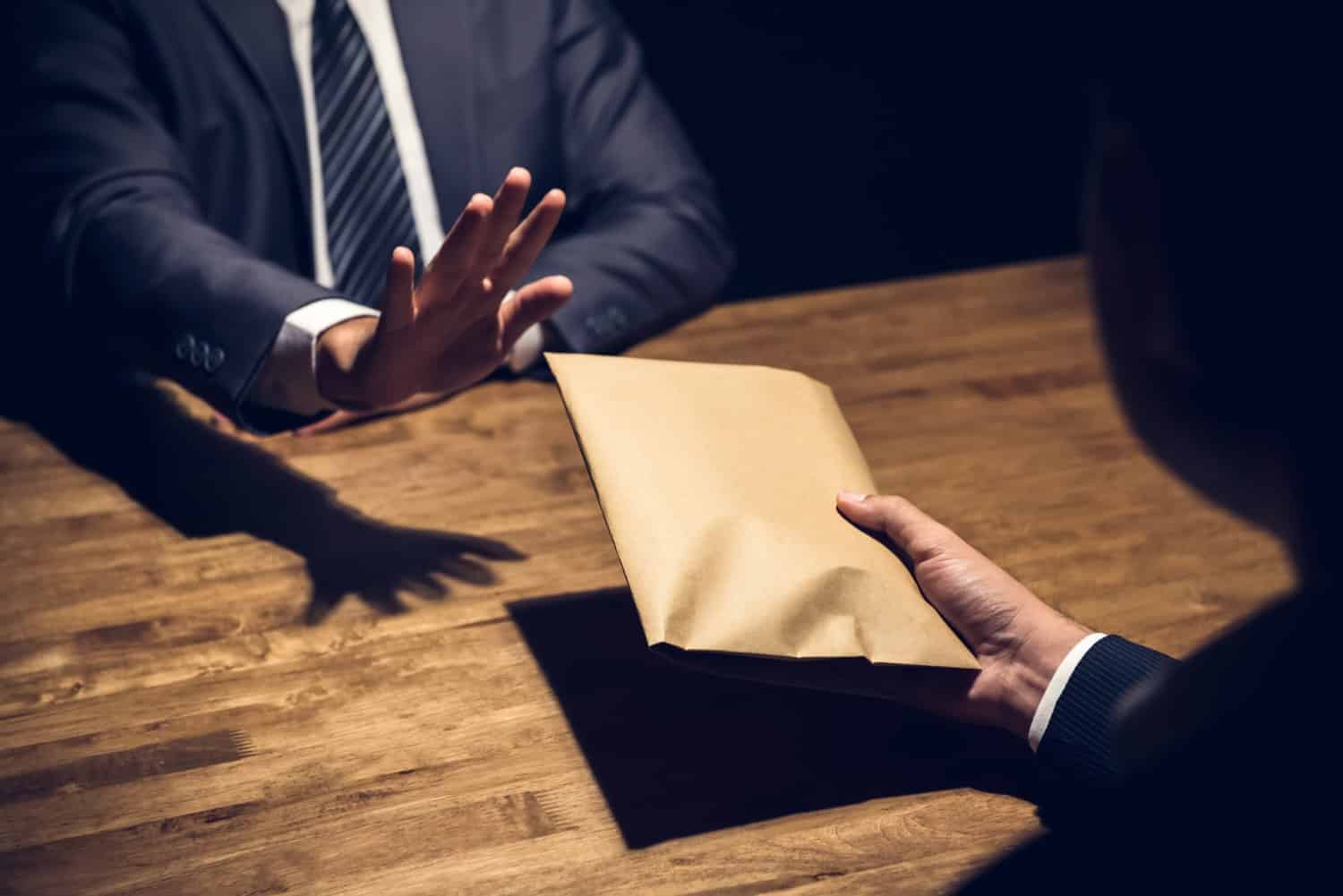Businessman rejecting money from loan shark