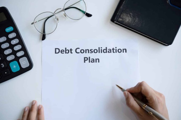 Woman writing debt consolidation plan in paper