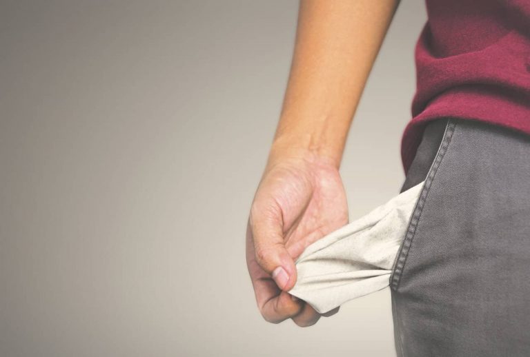 Man with empty pocket declaring bankruptcy